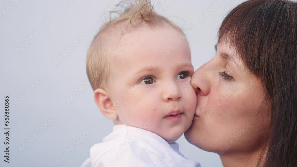 mom kisses baby. happy family little baby kid dream concept. mom kisses and hugs little newborn son. portrait of love a little newborn son mom kisses baby. happy family little baby kid dream concept. mom kisses and hugs little newborn son. portrait of love a little newborn son