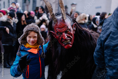 Procession of the Krampus Bavarian tradition in Germany. Costume parade fashing procession. Scary demon make-up with horns for halloween. Zombie parade. Terrible scary masks. Folk German folklore photo