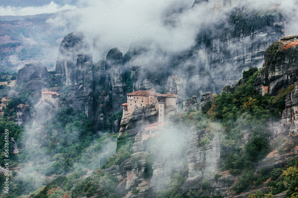 Fototapeta premium A monastery on the rocky mountains hidden in the mist