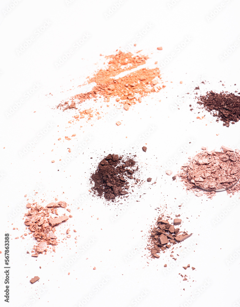 Scattered eye shadow and powder on white background Scattered eye shadow and powder on white background