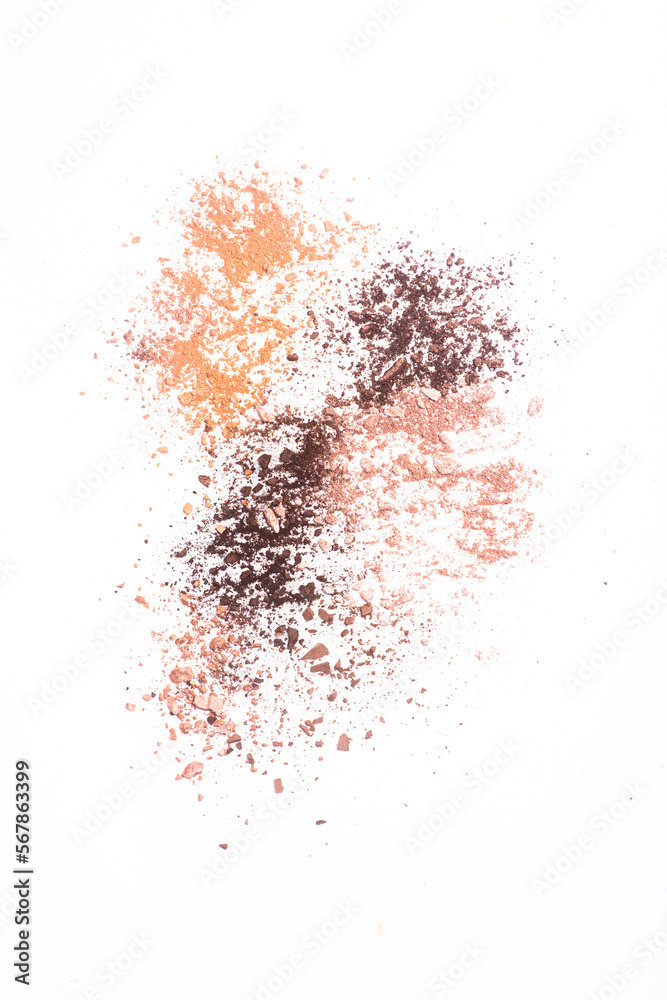 Scattered eye shadow and powder on white background
