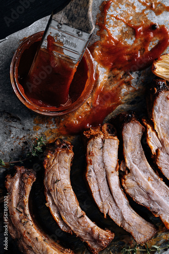 American cuisine concept. Grilled pork ribs with grilled sauce. American bbq ribs closeup. wood Dark background.