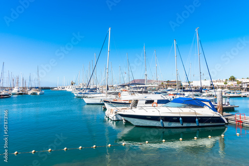 Marina Rubicon Playa Blanca coastal vacation resort, famous yachting port and market place, with volcanic mountains in the background. Lanzarote, Canary Islands, Spain. © Stockphototrends
