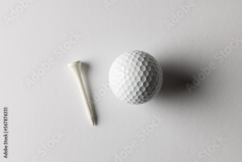 High angle view of white golf ball and golf tee with copy space on white background