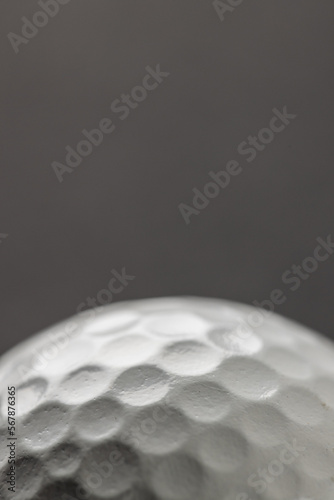 Close up of white golf ball with copy space on grey background