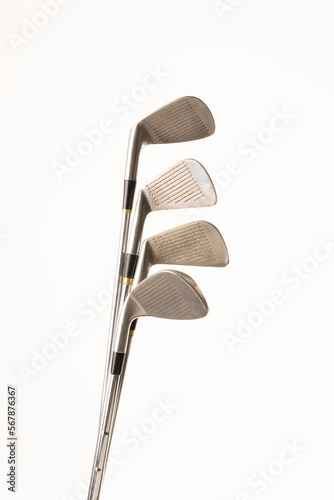 Close up of four golf clubs with copy space on white background