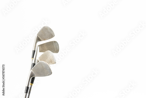 Close up of four golf clubs with copy space on white background