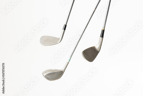 Close up of three golf clubs with copy space on white background