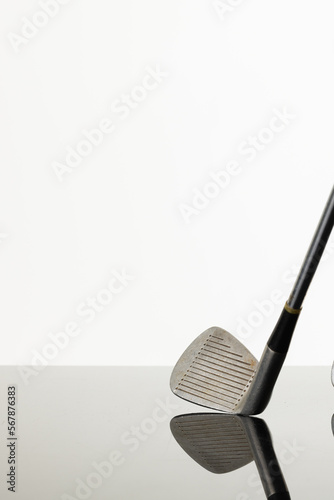 Close up of golf club with copy space and reflection on white background