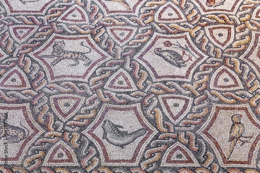 Fragment of Lod Mosaic, famous Roman mosaic floor in Lod town in Israel, displayed in Shelby White and Leon Levy Lod Mosaic Center. Mosaic depicts land animals, fish and two Roman ships.