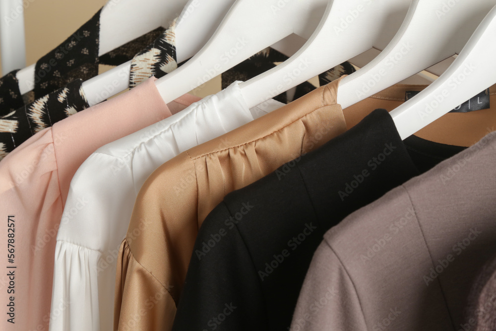 Women's Clothes. Close up image of clothes rack with stylish and elegant clothes in fashion atelier. Minimalist fashion blog concept.