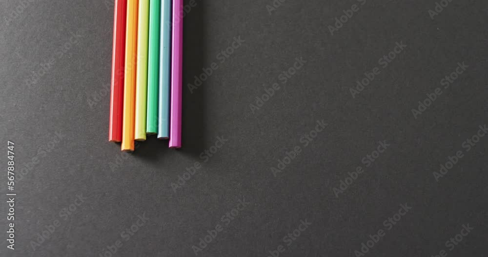 Video of rainbow straws over grey background with copy space Video of rainbow straws over grey background with copy space
