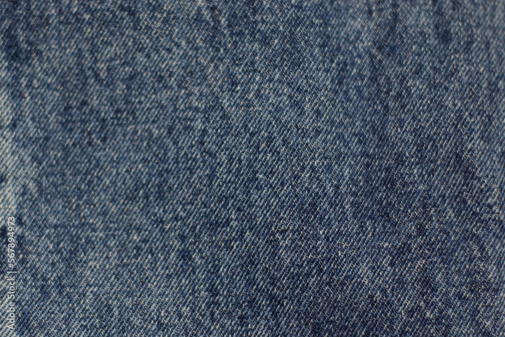 Denim fabric of a pair of jeans, blue. Denim fabric of a pair of jeans, blue.