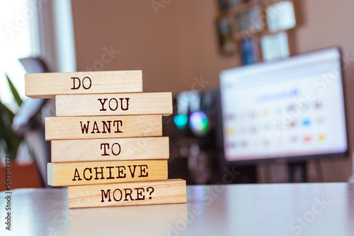 Wooden blocks with words 'Do you want to achieve more?'.