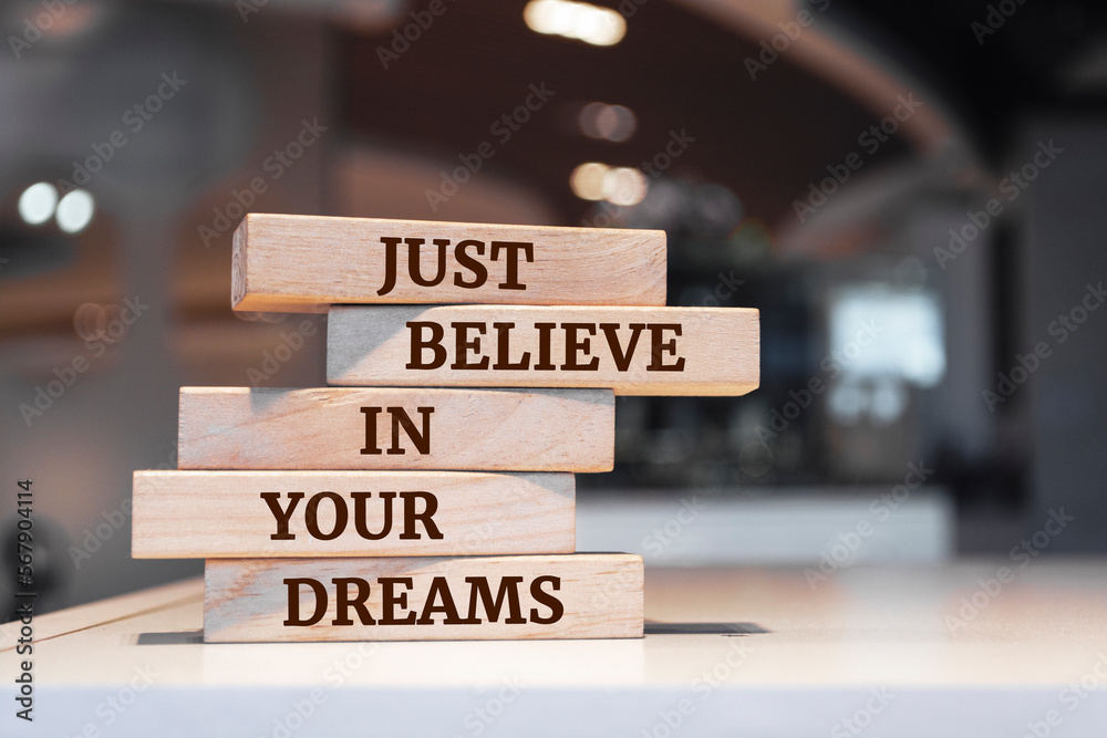 Wooden blocks with words 'Just believe in your dreams'.
