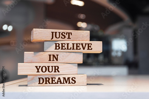 Wooden blocks with words 'Just believe in your dreams'.