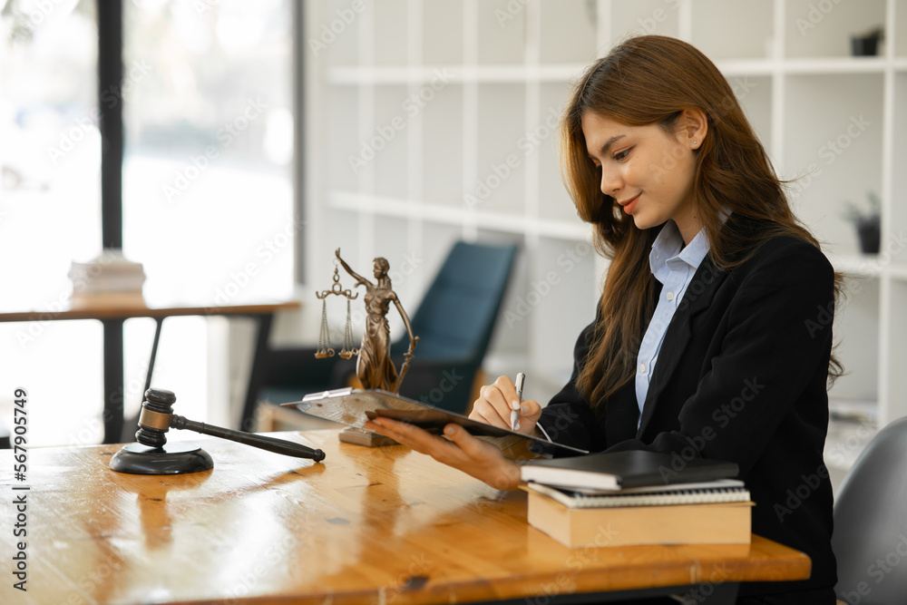 Female lawyer working at client's office discussing documents Female lawyer working at client's office discussing documents