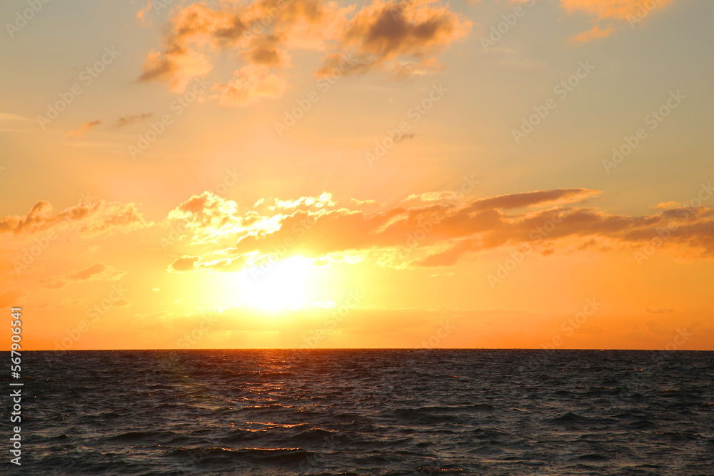 Picturesque view of sea under sky at beautiful sunset
