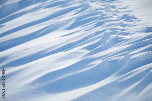 Abstract shadow and light patterns in winter snow landscape background