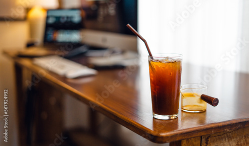 Iced black coffee on desk at home
