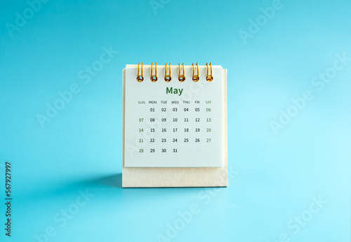 May 2023 calendar desk for the organizer to plan and reminder isolated on light blue background, minimal style. Small table calendar with the page of the fifth month.