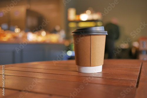 take away paper coffee cup o on cafe table