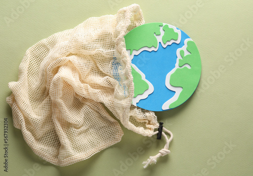 Fototapeta Naklejka Na Ścianę i Meble -  Eco bag with earth planet on green background. Plastic free