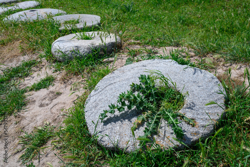 Ancient huge round stone millstones of the 6th-10th centuries of nomadic Turks in the Burana settlement in Kyrgyzstan photo