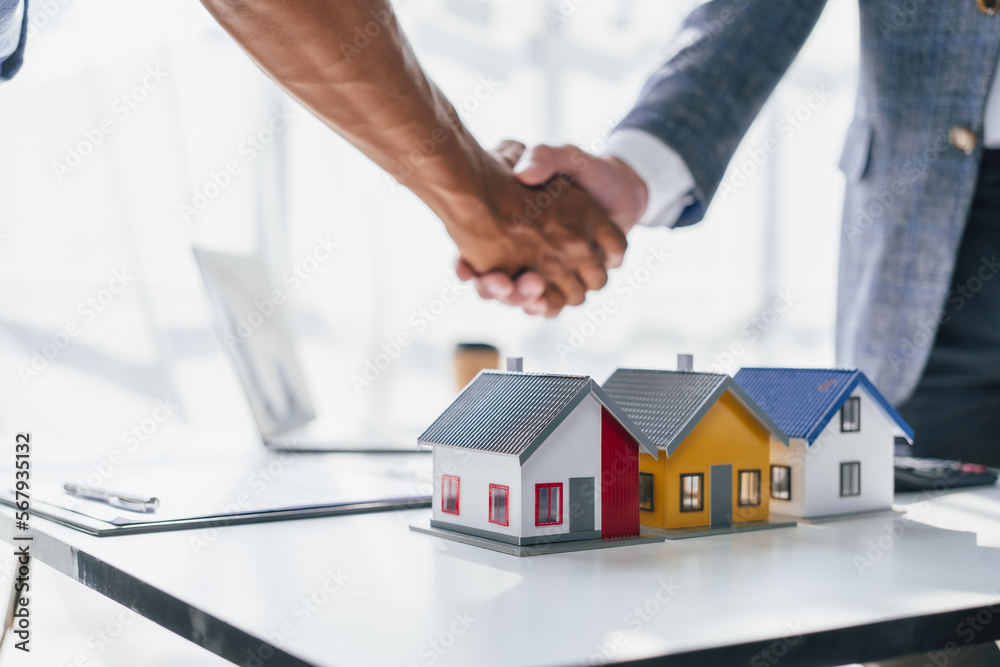Lawsuits against Real estate agent and realtor general liability insurance businessman professional discussing and consultant with house toy model building shaking hands after sign a contract Lawsuits against Real estate agent and realtor general liability insurance businessman professional discussing and consultant with house toy model building shaking hands after sign a contract