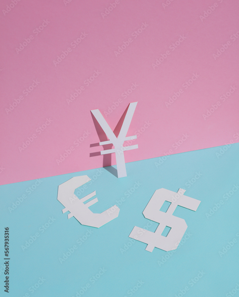 Obraz premium Different signs of currencies cut out of paper on a blue-pink background