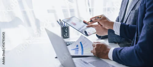 Obraz Using tablet pc, Consultant between bookkeepers and accounting lawyer consultation about asset, balance sheet, stock market statistics and yearly tax law, protect business from bribery.