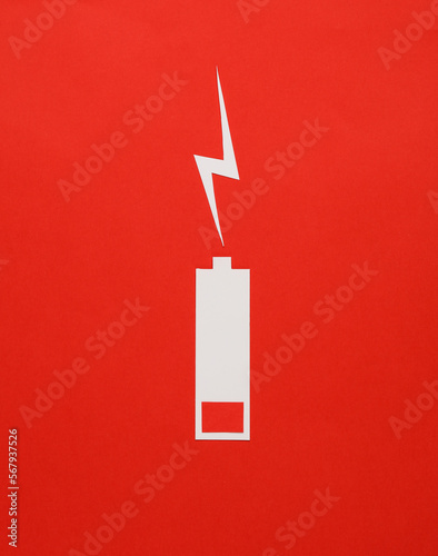 Foto Paper cut low battery on red background