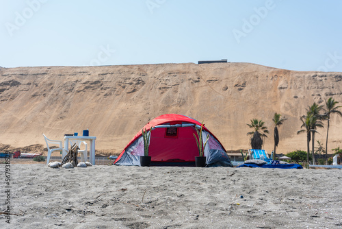 Background photos of a tent on the beach with a blue sky.