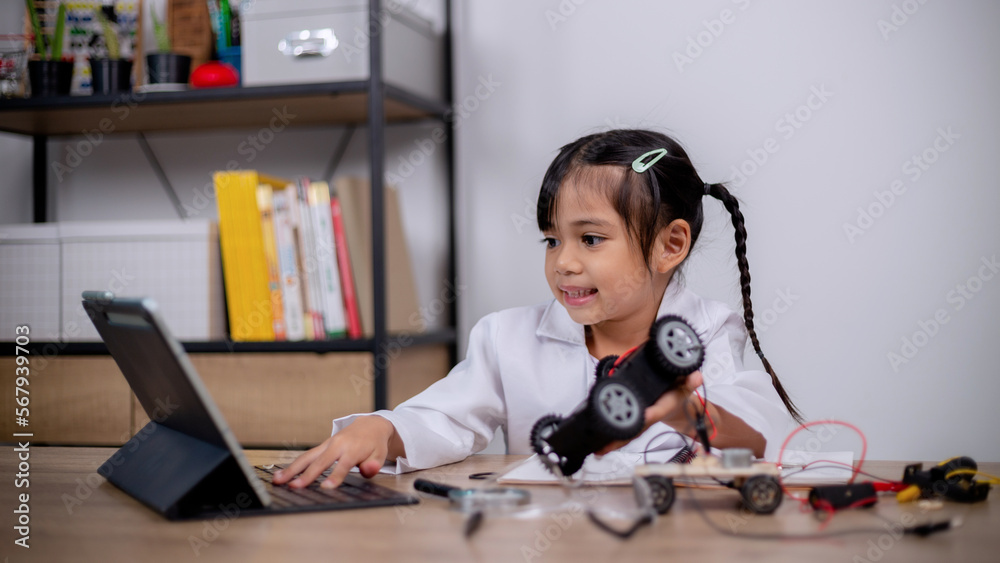 Asian students learn at home by coding robot cars and electronic board cables in STEM, STEAM, mathematics engineering science technology computer code in robotics for kids' concepts. Asian students learn at home by coding robot cars and electronic board cables in STEM, STEAM, mathematics engineering science technology computer code in robotics for kids' concepts.