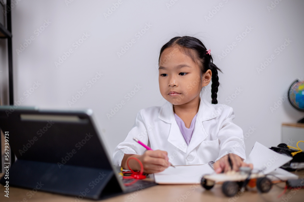 Asian students learn at home by coding robot cars and electronic board cables in STEM, STEAM, mathematics engineering science technology computer code in robotics for kids' concepts. Asian students learn at home by coding robot cars and electronic board cables in STEM, STEAM, mathematics engineering science technology computer code in robotics for kids' concepts.