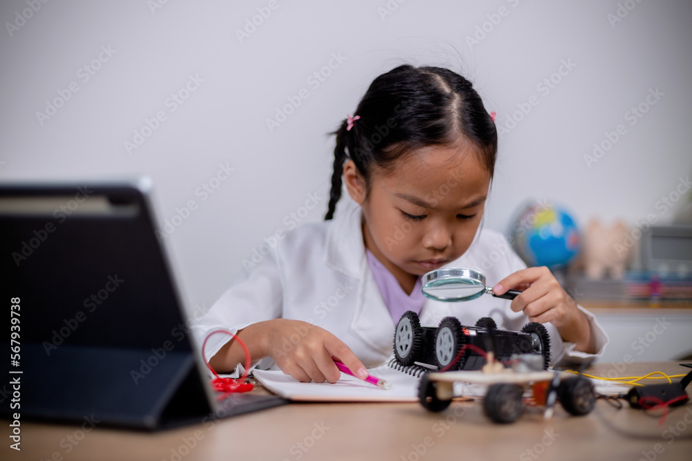 Asian students learn at home by coding robot cars and electronic board cables in STEM, STEAM, mathematics engineering science technology computer code in robotics for kids' concepts.