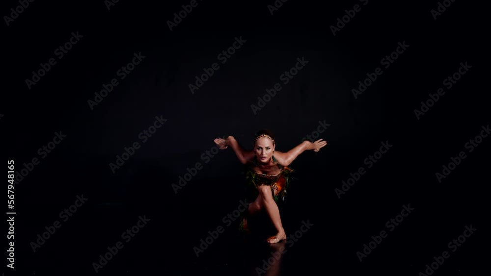 exotic dancer woman in black background, sexy lady dancing oriental dance in darkness