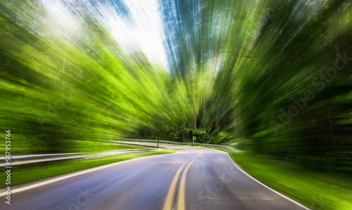  blur background., country road that looks like it moves towards a curve at high speed, blurring the background.