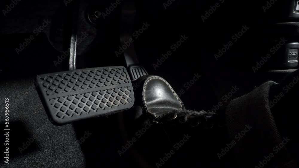 Accelerate and Brake. Foot pressing foot pedal of a car to drive ahead