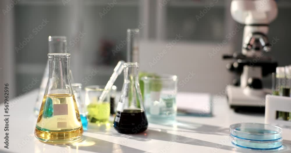 Flasks with yellow transparent liquid and black crude oil for research in laboratory Flasks with yellow transparent liquid and black crude oil for research in laboratory