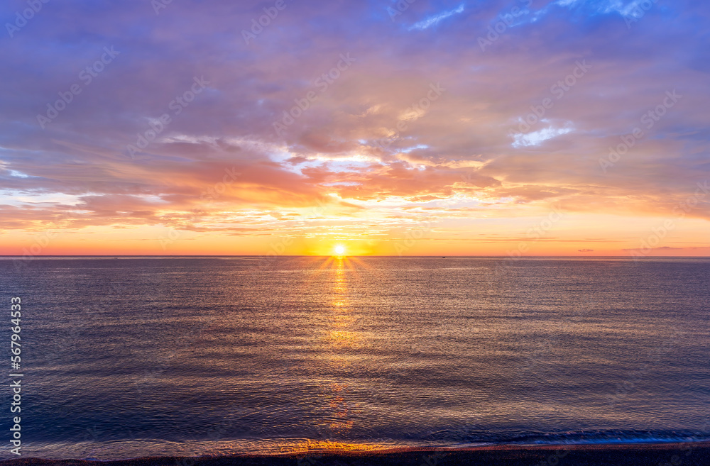 view at sunrise or sunset in sea with nice beach , surf , calm water and beautiful clouds on a background of a sea landscape