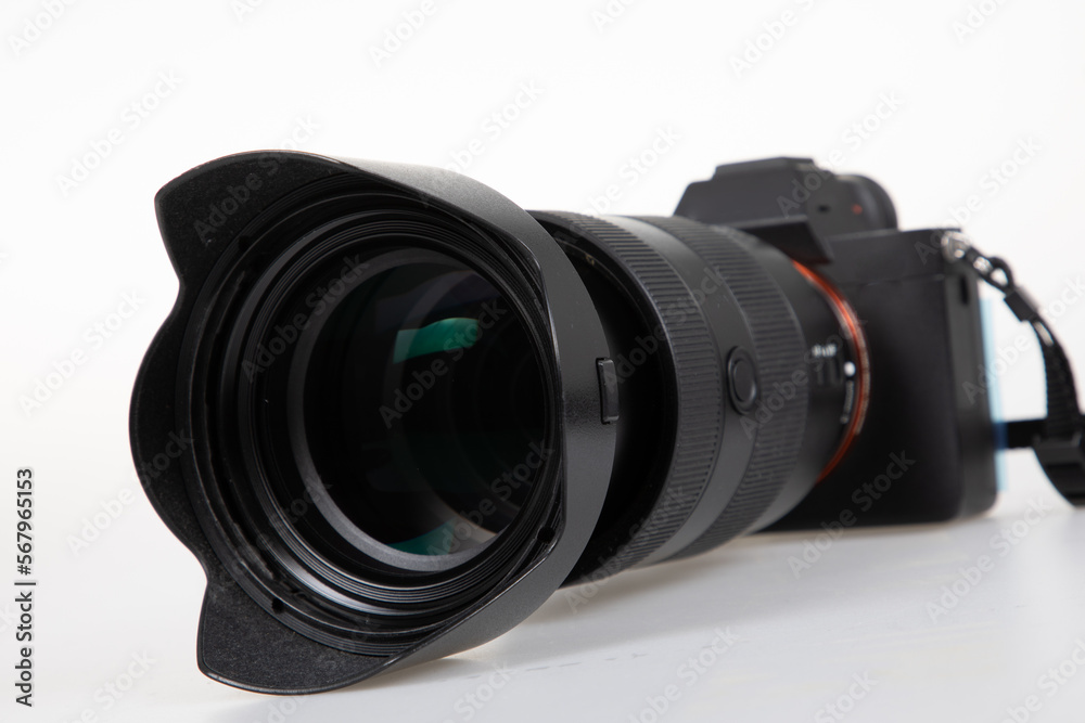 DSLR Camera with black zoom lens in white background on front view DSLR Camera with black zoom lens in white background on front view