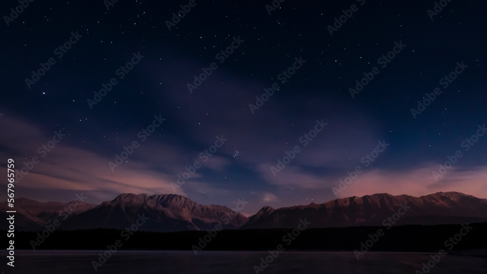 Nighttime starscape of a mountain lake in the Canadian Rocky Mountains, Kananaskis Country Alberta, Canada