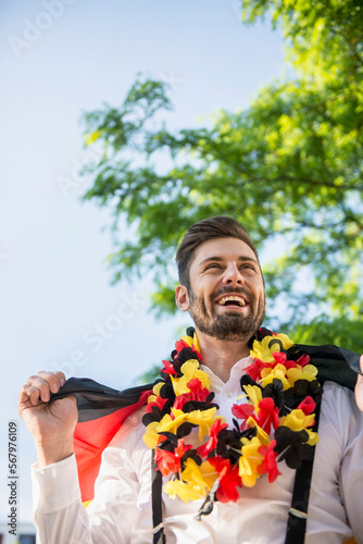 Excited male soccer fan watching soccer, Munich, Bavaria, Germany photo