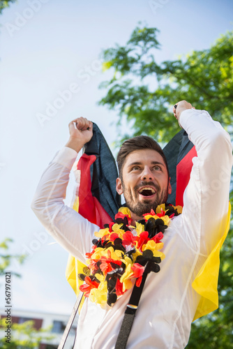 Excited male soccer fan watching soccer, Munich, Bavaria, Germany photo