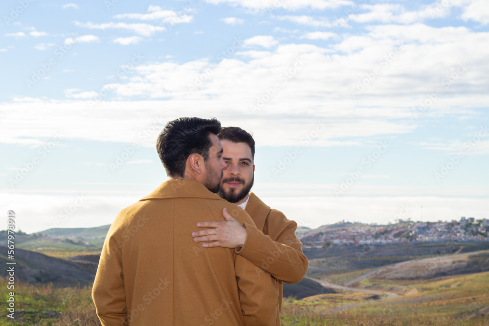 portrait of gay caucasian man hugging his latino boyfriend in mountain portrait of gay caucasian man hugging his latino boyfriend in mountain