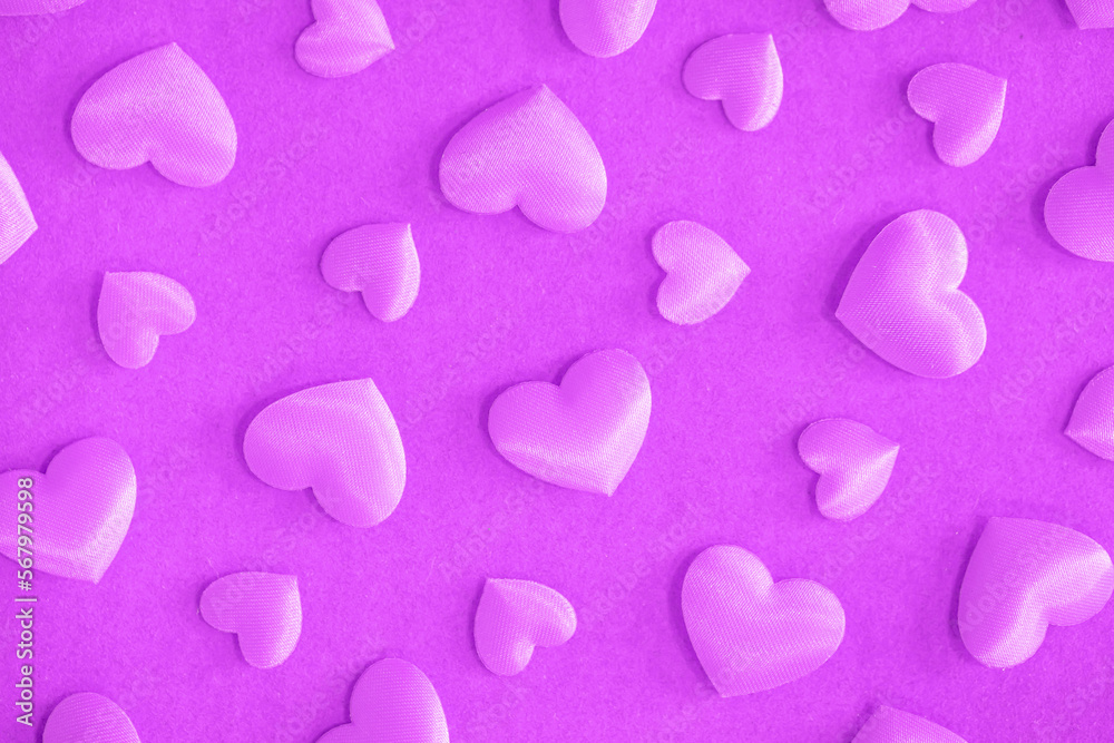 Background from hearts and sparkles. Pink hearts on a pink background top view. Background for love flat lay. The concept of a holiday, miracles and surprises.