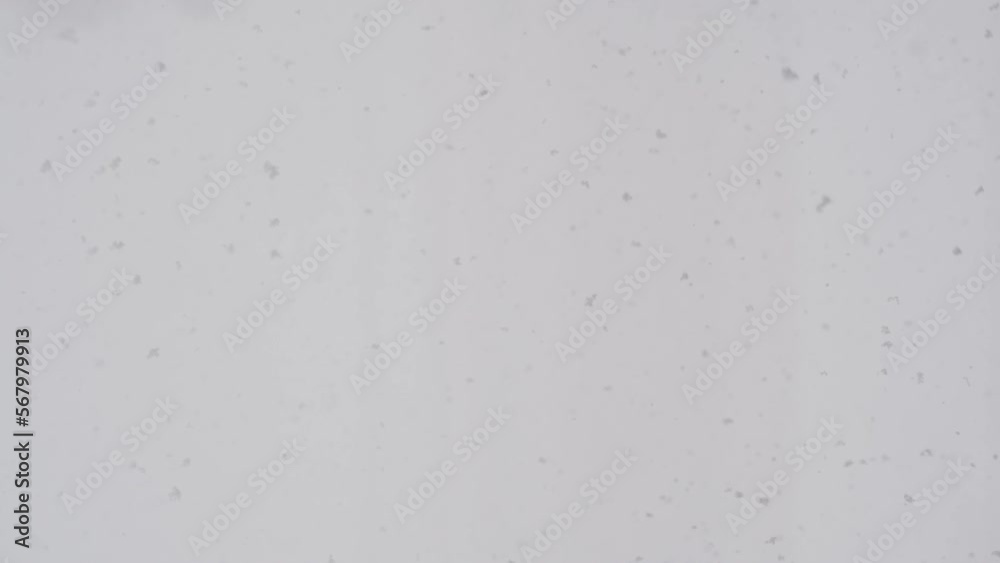 Slow motion snow falling over white clouds Slow motion snow falling over white clouds