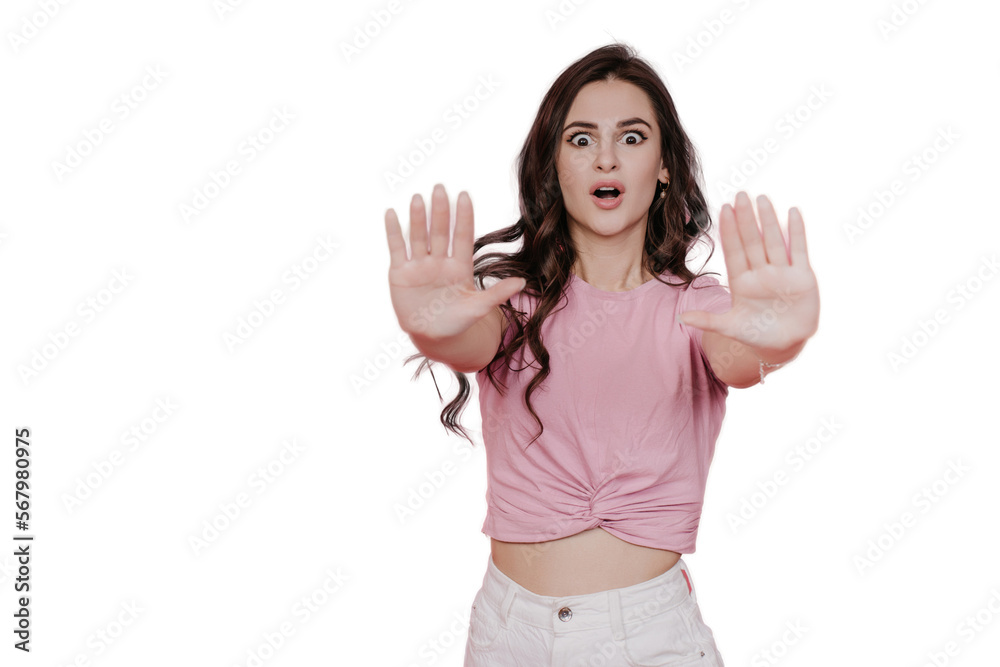 Brunette shocked young woman in pink t-shirt with wide opened eyes pulling hands to camera makes stop gesture, stands against transparent background. Don’t pass by. Mockup, discount, sale. Brunette shocked young woman in pink t-shirt with wide opened eyes pulling hands to camera makes stop gesture, stands against transparent background. Don’t pass by. Mockup, discount, sale.