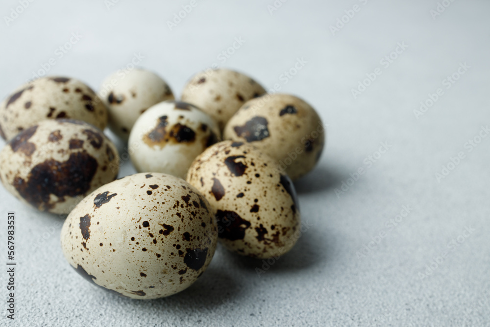 Quail eggs on light gray background. Easter concept. Natural, organic farm products. Close up. Copy space. Place for text Quail eggs on light gray background. Easter concept. Natural, organic farm products. Close up. Copy space. Place for text